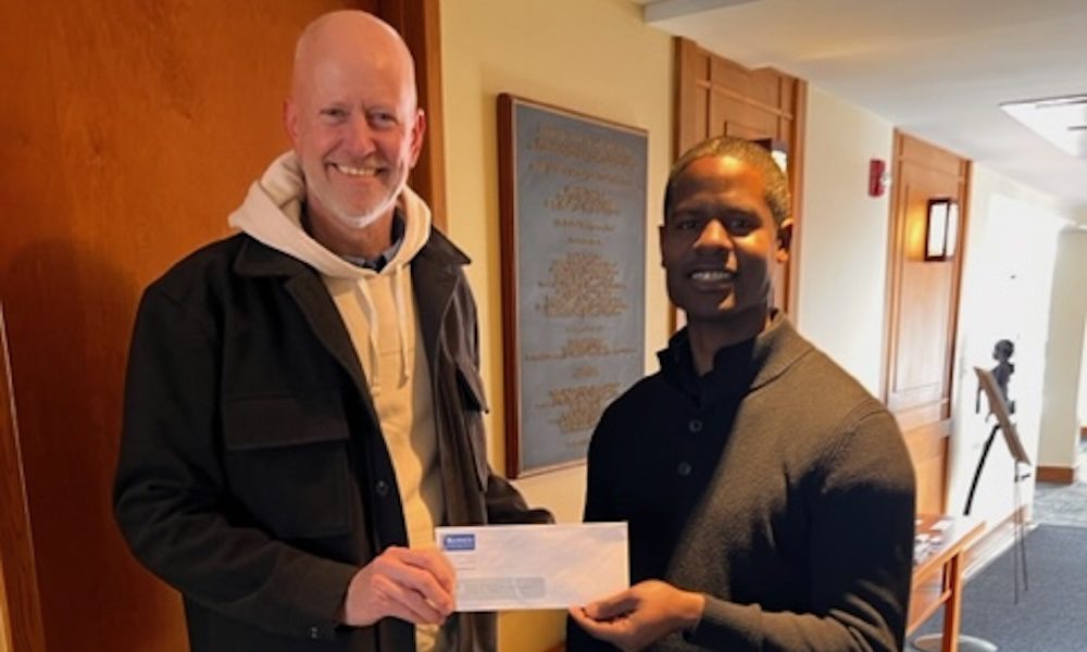 Quote for a Cause - Libby’s Place at Aurora University - Brian Konen (left) is pictured handing a check to Justin West, Executive Director of the Wackerlinlin Center for Faith and Action